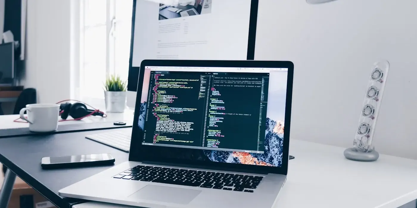 Software engineer writing code on a laptop